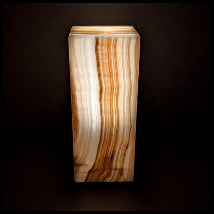 Stone lamp lit up against a dark background