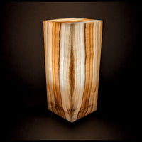 Stone lamp lit up against a dark background