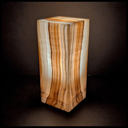 Stone lamp lit up against a dark background