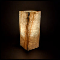 Stone lamp lit up against a dark background