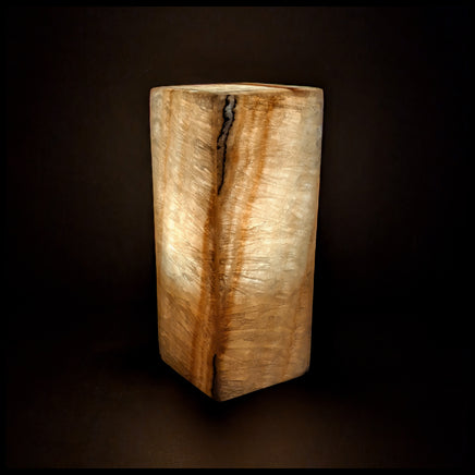 Stone lamp lit up against a dark background